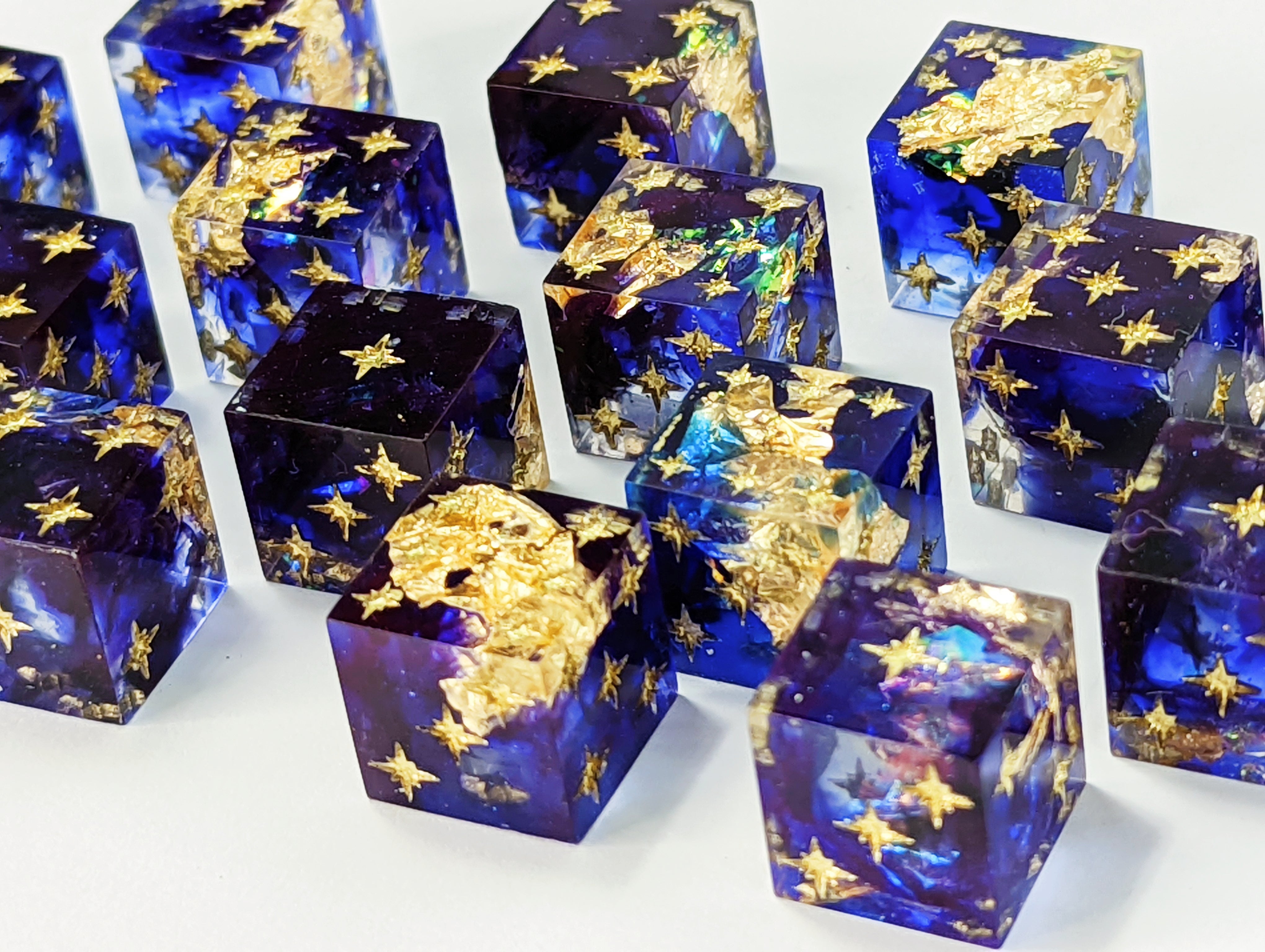 Deep sapphire blue with a swirl of black. Big gold leaf flakes and flashes of color hid deep within the depth of blue. Inked in gold.